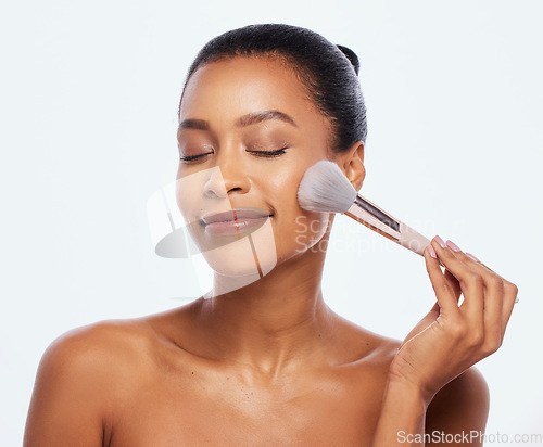 Image of Beauty, makeup and brush for face of woman in studio for makeup, cosmetics and natural skin. Aesthetic model person with facial tools for a healthy glow or shine isolated on a white background