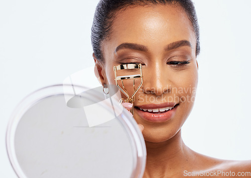 Image of Makeup, beauty and eyelash curler by black woman doing self care or skincare isolated against a studio white background. Happy, cosmetics and face of female model holding product or tool