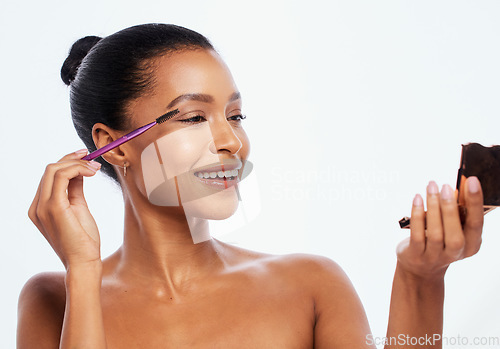 Image of Makeup, beauty and woman with eyebrow brush and mirror using cosmetic product isolated in studio white background. Face, dermatology and model with elegant and smooth skin as self care routine