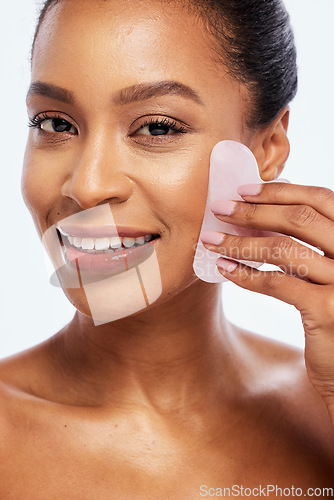 Image of Skin care, gua sha and face massage for woman portrait in studio for dermatology and natural glow. Happy aesthetic model person with spa stone for healthy facial shine isolated on a white background