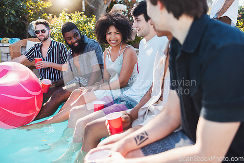 Image of Holiday, drinks and people speaking in a pool at a summer party, celebration or event at a home. Diversity, vacation and friends talking, having fun and bonding by the swimming pool while drinking.