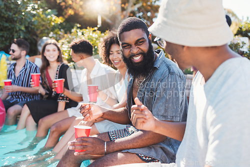 Image of Vacation, drinks and friends speaking in a pool at a summer party, celebration or event at a home. Diversity, happy and people talking, having fun and bonding by the swimming pool while drinking.