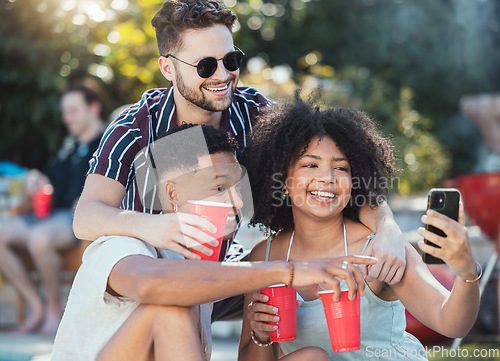 Image of Friends, selfie and party outdoor, drinks and playful in summer, bonding together and celebration. Young people, men and black woman with smartphone, share picture or event outside, alcohol and smile