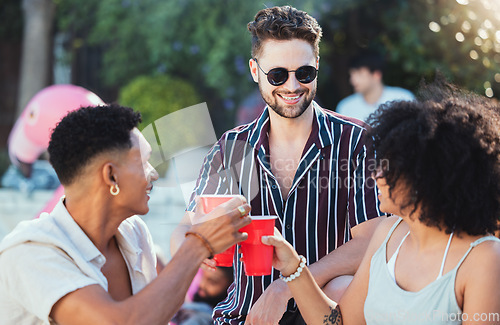 Image of Party, diversity and cheers with friends outdoor together in summer for a social gathering or celebration event. Alcohol, toast or birthday with a young man and woman friend group celebrating outside