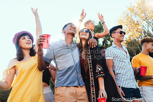 Image of Drinks, party and a couple of friends dancing outdoor to celebrate at festival, concert or social event. Diversity young men and women people together while happy, singing and drinking alcohol