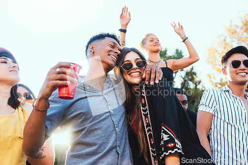 Image of Outdoor party, drinks and a couple of friends celebrate at festival, concert or summer social event. Diversity young men and women people together while dancing, happy and drinking alcohol in crowd