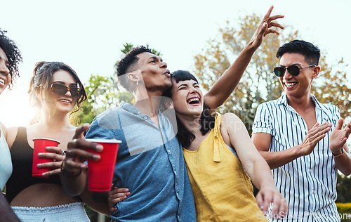 Image of Drinks, party and a couple of friends dancing outdoor to celebrate at festival, concert or social event. Diversity young men and women people together in summer, happy and drinking alcohol in crowd