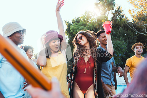 Image of Pool party, drinks and group of friends outdoor to celebrate at festival, location or summer social event. Diversity young men and women people together while dancing, happy and drinking alcohol