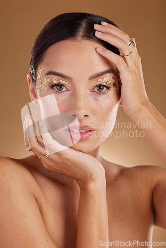 Image of Cosmetics portrait, face glitter and woman with luxury gold eyeshadow, beauty product and studio skincare glow. Makeup, spa salon or aesthetic model girl with jewelry ring, accessories and wellness