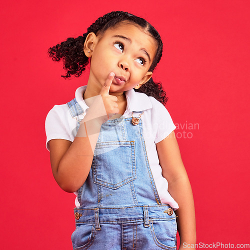 Image of Child, face or thinking finger on chin on isolated red background in games innovation, question or planning vision. Little girl, kid or curious expression in ideas, fashion clothes or curly hairstyle