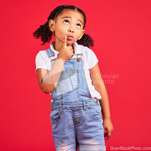 Image of Kid, face or thinking finger on chin by isolated red background in games innovation, question or planning vision. Little girl, ideas or curious expression for child fashion clothes or curly hairstyle