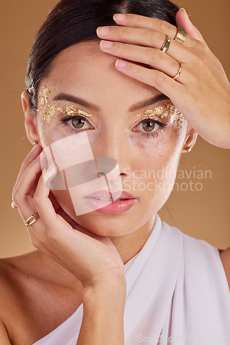 Image of Gold makeup, face glitter or woman with luxury eyeshadow, cosmetics product and skincare glow. Beauty girl, spa salon or aesthetic portrait model with jewelry ring, accessories or vitiligo healthcare