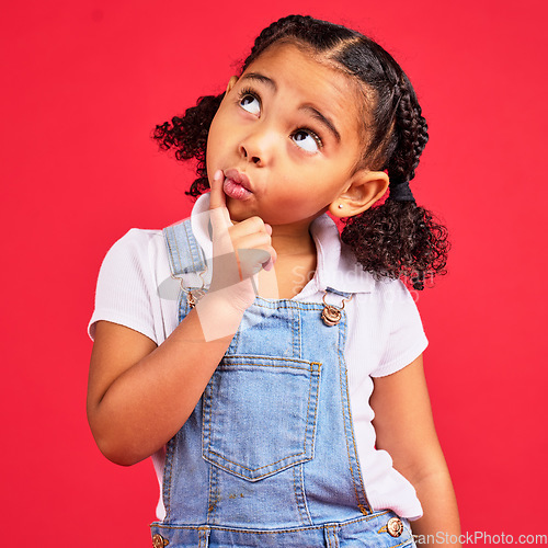 Image of Little girl, ideas or thinking face by isolated red background in games innovation, question or planning vision. Kid, expression or curious finger on chin, children fashion clothes or curly hairstyle