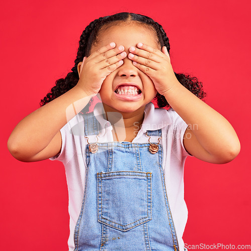 Image of Child, hands and eyes cover on isolated red background with angry, mad or stubborn facial expression. Girl, kid and youth hiding face in tantrum, autism or adhd for behaviour issue, crisis or problem