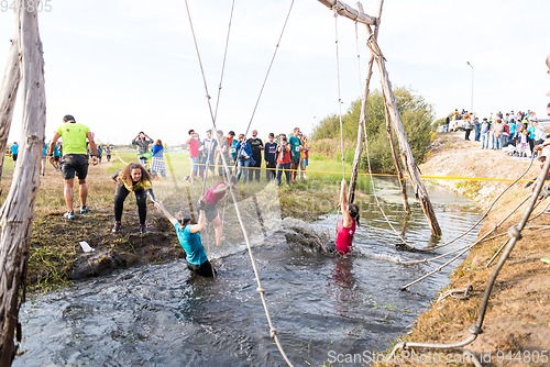 Image of Athletes go through mud and water