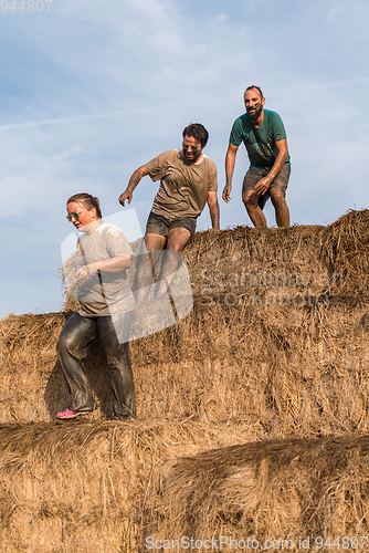 Image of Athletes overcoming the hay osbtacle