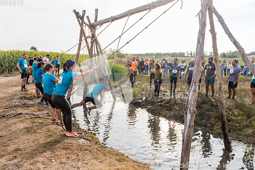 Image of Athletes go through mud and water