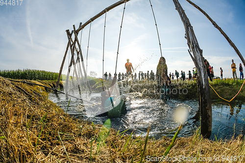 Image of Athletes go through mud and water