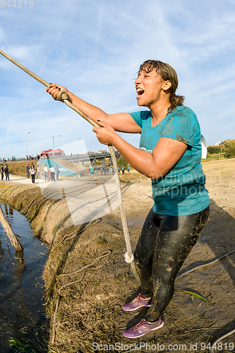 Image of Athlete go through mud and water