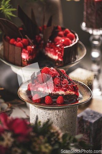 Image of Slice of cheesecake with raspberry sauce