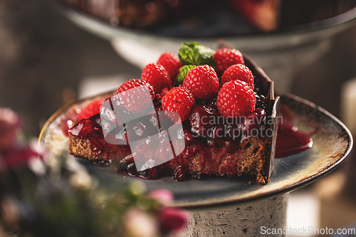 Image of Slice of chocolate cake with cherry sauce