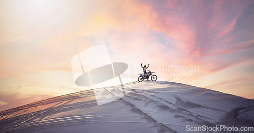 Image of Desert, sunset and man riding a motorcycle for exercise, fitness or skill training in nature. Extreme sports, dusk and male athlete on a bike for an outdoor evening workout in the sand dunes in Dubai