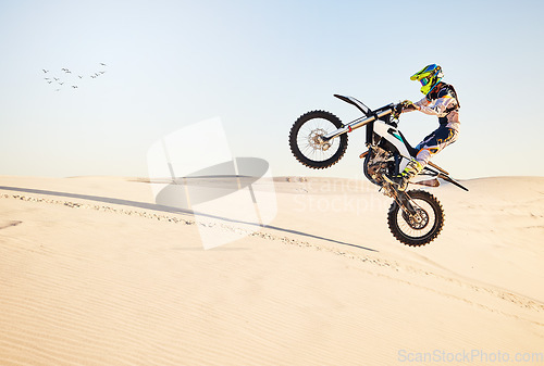 Image of Motorcycle, desert race and air jump for extreme sport expert with agile speed, power or balance in nature. Motorbike man, rally and blue sky on fast vehicle with helmet, safety clothes or motivation