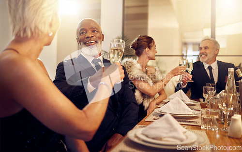 Image of Man, toast and friends at restaurant party in night for diversity, business executive team and success. New year, celebration talk and people at gala with champagne, congratulations and solidarity