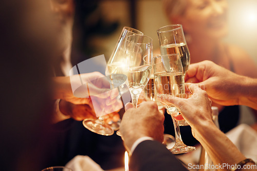 Image of Success, hands or toast in a party for goals, winning deal or new year at luxury social event celebration. Motivation, team work or people cheers with champagne drinks or wine glasses at dinner gala