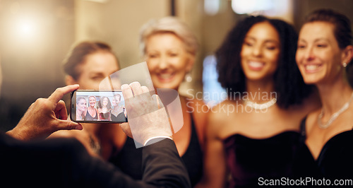 Image of Phone, photography or friends in a party in celebration of goals or new year at fancy luxury night event. Girls, screen or happy women take pictures for social media at dinner gala or fun birthday