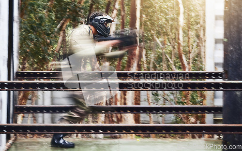 Image of Paintball, gun and sport speed of a man doing workout and fitness performance for soldier training. Cardio, shooting and camouflage games of a young athlete with energy and cardio for outdoor game