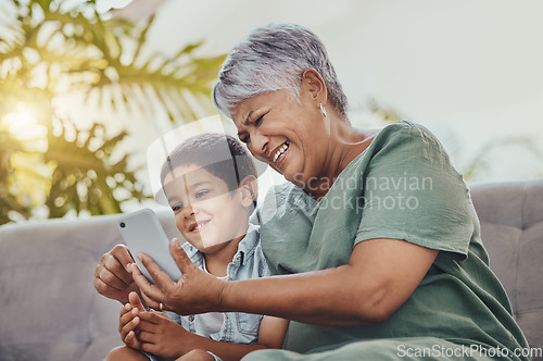 Image of Smartphone, family or grandmother with child for meme, funny or watch online cartoon on mobile app and sofa. Happy, laugh and senior woman with kid on cellphone for comedy video and internet at home