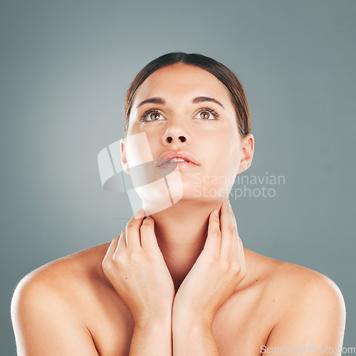 Image of Woman, beauty and hands on neck in skincare satisfaction for cosmetic treatment against grey studio background. Face of beautiful female touching soft, smooth or perfect skin for healthy wellness