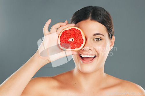 Image of Grapefruit, skincare, woman or aesthetic wellness for healthy diet, happy results or clean glowing on grey background. Beauty portrait, smile or girl model face, facial makeup or cosmetics for health