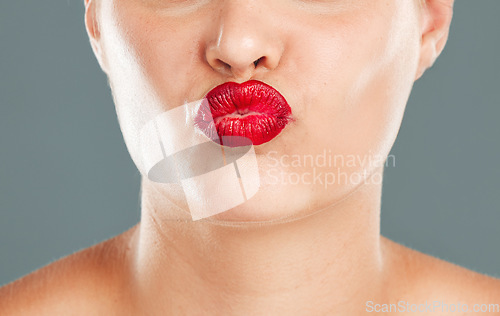 Image of Kiss face zoom, lipstick and woman lips with makeup, red cosmetics and pout isolated on studio background. Healthy skin, beauty and skincare with cosmetic care, wellness and facial glow with shine