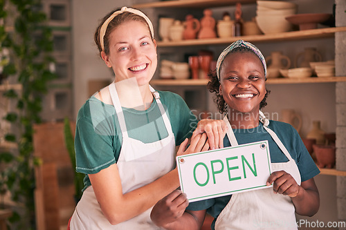 Image of Small business, pottery and women team with open sign for creative workshop, art studio and startup. Smile, teamwork and entrepreneurs ready for welcome to ceramics, clay sculpture and artwork store