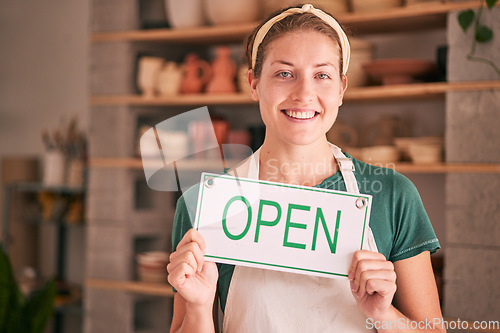 Image of Woman, small business and open sign for creative startup, welcome or entrepreneurship at retail store. Portrait of happy owner in pottery shop with smile holding opening board in ready for service