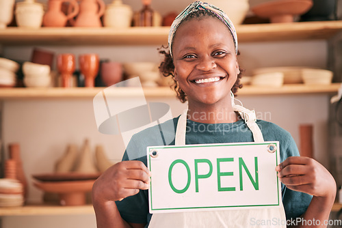 Image of Small business, pottery and black woman with open sign for creative workshop, art studio and startup. Manager, entrepreneur and girl happy for welcome to ceramics, clay sculpture and artwork store