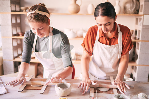 Image of Pottery, design and small business people in workshop teamwork, collaboration and startup production. Clay, manufacturing and creative woman, artist or partner working together on sculpture process