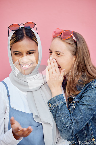 Image of Secret, happy and talking friends in the city, sharing gossip and listening to a story in Morocco. Smile, conversation and women in communication, whispering and speaking about a joke on a backdrop