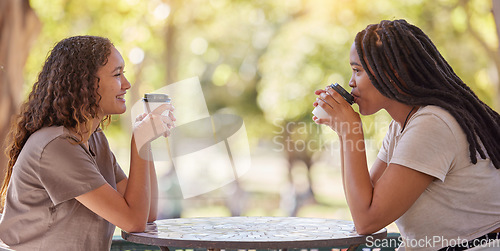 Image of Woman, friends and drinking coffee at cafe for conversation, social life or communication outside. Happy women enjoying friendly discussion, talk or gossip together in friendship at coffee shop