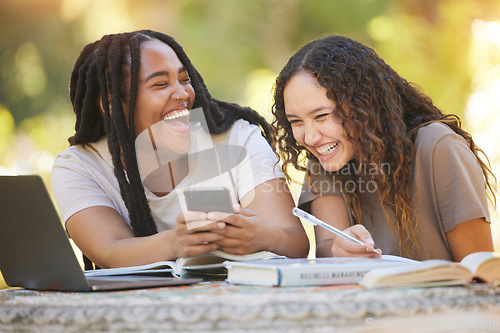 Image of Students, friends and women with phone at park laughing at funny meme. University scholarship, comic and happy girls or females with mobile smartphone laugh at joke or crazy comedy on social media.