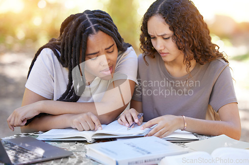 Image of Students, confused and reading book, help and studying at park. University, education teamwork and doubt or uncertain women or friends learning, research or helping with textbook assignment outdoors