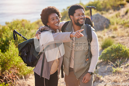 Image of Mountain, happy or black couple love hiking in nature for exercise, workout or training on summer holiday. Travel, woman and African partner pointing, trekking or walking to hill on outdoor adventure