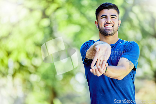 Image of Exercise, mockup or stretching arm with a man outdoor in nature for a warm up before a workout. Fitness, mock up and training with a male athlete on a natural green background for health or cardio