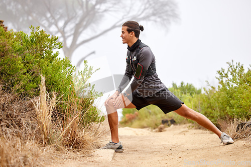 Image of Stretching legs, running and man on nature trail for fitness, marathon training and cardio workout outdoors. Sports, body performance and happy male athlete warm up for wellness, exercise and balance