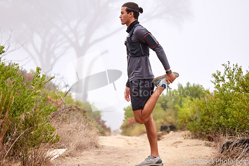 Image of Fitness, stretching legs and man on nature trail for running, marathon training and cardio workout outdoors. Sports, healthy body and focused male athlete warm up for wellness, exercise and hiking