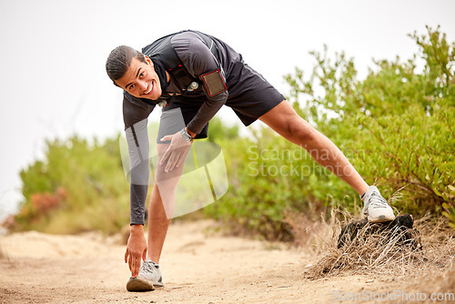 Image of Stretching legs, exercise and man on nature trail for running, marathon training and cardio workout. Sports, healthy body and portrait of happy male athlete warm up for wellness, exercise and balance