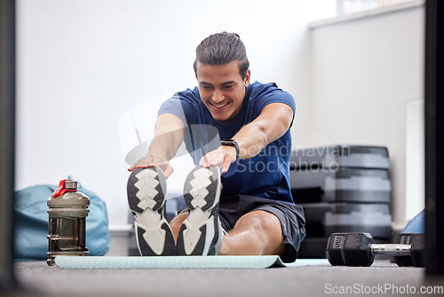 Image of Fitness, exercise or man stretching legs to start training, workout or warm up to relax muscles in body. Wellness, flexible or healthy sports athlete with a happy smile exercising in a gym in Brazil