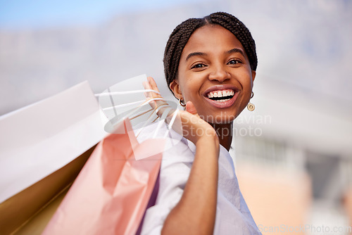 Image of Shopping bag, black woman and smile portrait outdoor with retail bags after sale and sales promotion. Happy, customer and excited young person in nature feeling freedom after deal and mall discount